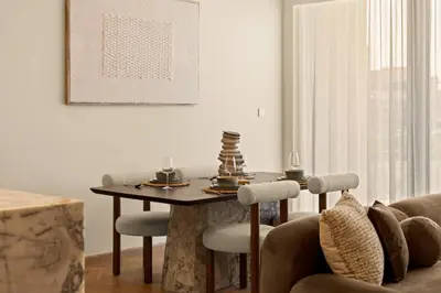 a living room with a table and a couch at Seraya at Grande Signature Residences in Dubai