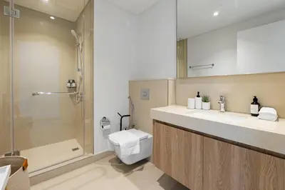 a bathroom with a sink and a toilet and a shower at Burj Khalifa Views at Downtown Views II 3 Bedroom Apartment in Dubai