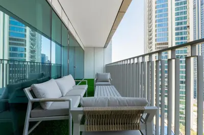 a balcony with chairs and tables on a building at Burj Khalifa Views at Downtown Views II 3 Bedroom Apartment in Dubai