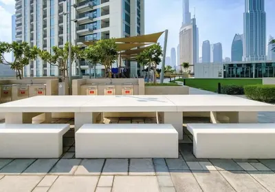 a white picnic table and benches in a city at Downtown Views II 2 Bedroom Apartment Next to Dubai Mall in Dubai
