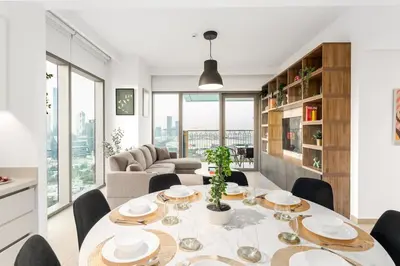 a dining room with a table and chairs and a couch at Stunning Corner 2 Bedroom in Downtown Views II in Dubai