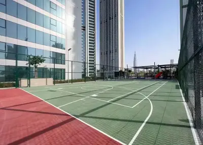 a tennis court in a city with tall buildings at Stunning Corner 2 Bedroom in Downtown Views II in Dubai