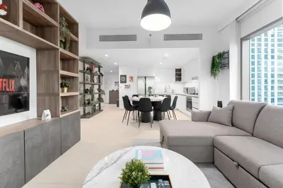 a living room with a couch and a table at Stunning Corner 2 Bedroom in Downtown Views II in Dubai