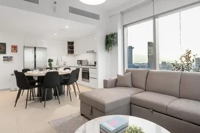 a living room with a couch and a table at Stunning Corner 2 Bedroom in Downtown Views II in Dubai