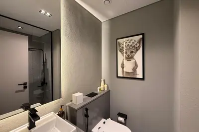a bathroom with a toilet and a sink and a mirror at Stylish Studio in Meydan 10mins away Burj Khalifa in Dubai