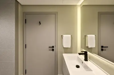 a bathroom with a white sink and a mirror at Stylish Studio in Meydan 10mins away Burj Khalifa in Dubai