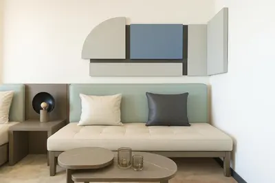 a living room with a couch and a table at Stylish Studio in Meydan 10mins away Burj Khalifa in Dubai