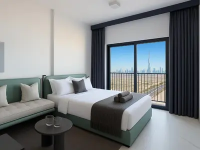 a bedroom with a bed and a couch and a large window at Modern Studio in Meydan - Minutes from Dubai Mall in Dubai