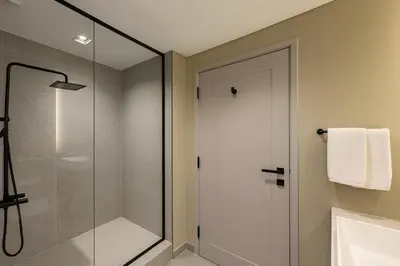 a bathroom with a shower and a glass shower door at Modern Studio in Meydan - Minutes from Dubai Mall in Dubai