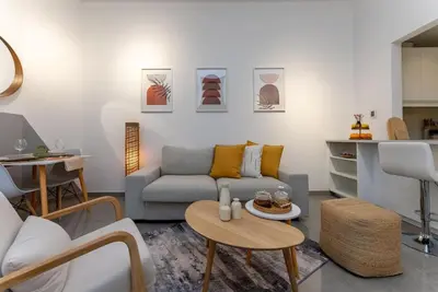a living room with a couch and a table at Marina Wharf 1 Bedroom with JBR Beach Views in Dubai