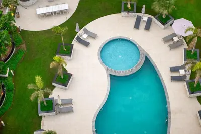 an overhead view of a swimming pool in a resort at Marina Wharf 1 Bedroom with JBR Beach Views in Dubai