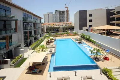 an overhead view of a swimming pool on a building at Contemporary JVC Studio with Rooftop Pool Gym in Dubai