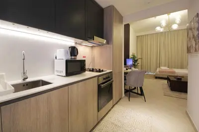 a kitchen with a sink and a counter top at Contemporary JVC Studio with Rooftop Pool Gym in Dubai