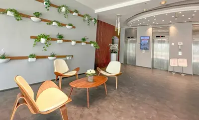 a waiting room with chairs and a table at Apartment Close to Metro in Dubai Marina in Dubai