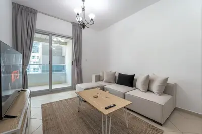 a living room with a couch and a table at Apartment Close to Metro in Dubai Marina in Dubai