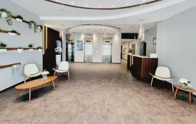 a lobby with chairs and a reception desk in a building at Apartment Close to Metro in Dubai Marina in Dubai