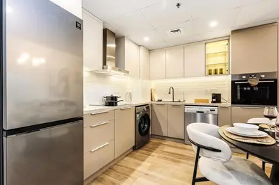 a kitchen with a table and a dining room at Luxury 1BR Dubai Marina Apartment Walk to JBR Beach & Marina Yacht Club in Dubai