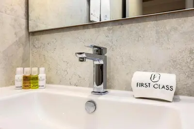 a bathroom sink with a faucet and a first class towel at Luxury 1BR Dubai Marina Apartment Walk to JBR Beach & Marina Yacht Club in Dubai