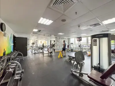 a gym with chairs and a man walking in the room at Luxury 1BR Dubai Marina Apartment Walk to JBR Beach & Marina Yacht Club in Dubai