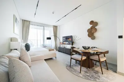 a living room with a couch and a table at SettlerHomes - Private Jacuzzi Oasis on the High-Floor in Dubai