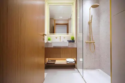 a bathroom with a sink and a shower at SettlerHomes - Private Jacuzzi Oasis on the High-Floor in Dubai