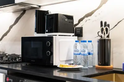 a microwave oven sitting on top of a counter at SettlerHomes - Private Jacuzzi Oasis on the High-Floor in Dubai