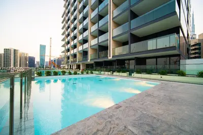 a large swimming pool in front of a building at SettlerHomes - Private Jacuzzi Oasis on the High-Floor in Dubai