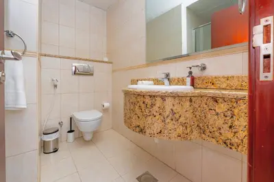 a bathroom with a sink and a toilet and a mirror at Duplex Penthouse on 73rd Floor in Dubai Marina in Dubai