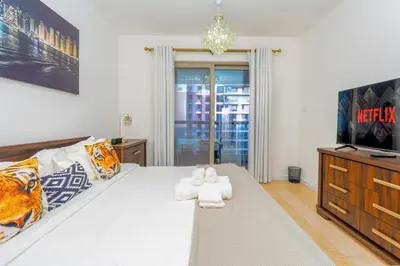 a bedroom with a bed with two towels on it at Duplex Penthouse on 73rd Floor in Dubai Marina in Dubai