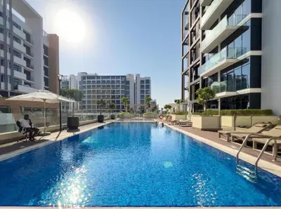 a large swimming pool in the middle of a building at Stylish 1BR near Business Bay, Meydan Racecourse & Crystal Lagoon in Dubai
