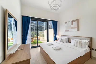 a bedroom with a large bed and a large window at Stylish 1BR near Business Bay, Meydan Racecourse & Crystal Lagoon in Dubai