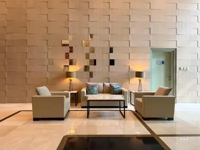 a lobby with two couches and a table and chairs at The Lofts, Burj Khalifa View in Dubai