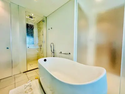 a white bath tub in a bathroom with a shower at Luxe 3BR , Paramount by DAMAC, Excellent Pool in Dubai