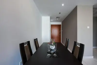 a dining room with a black table and chairs at Best View in Marina Dubai in Dubai