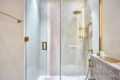 a shower with a glass door in a bathroom at Charming Studio with Scenic Canal Views in Dubai