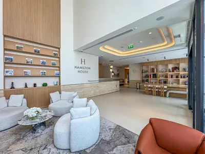 a lobby of a hotel with couches and chairs at Bright Studio in JVC with Pool and Gym Access in Dubai
