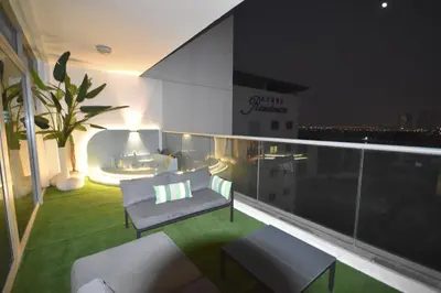a balcony with a couch and chairs on a building at Highend Azure 1BR Sea View and Private Beach with Pool Access in Dubai