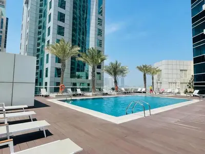 a swimming pool in the middle of a building at Silk Valley - Cozy Studio steps away from the Beach and Marina in Dubai