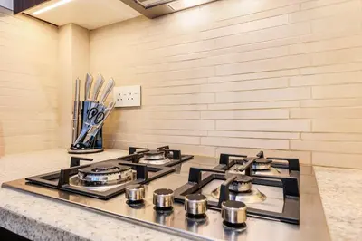 a kitchen with three burners on top of a stove at FIRST CLASS 1BR Stylish Gem Near Dubai Mall in Dubai