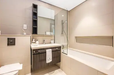 a bathroom with a sink and a shower at FIRST CLASS 1BR Stylish Gem Near Dubai Mall in Dubai