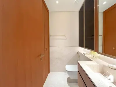 a bathroom with a toilet and a sink at Seafront Serenity Palm Escape with Pool Access in Dubai