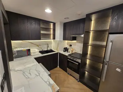 a kitchen with marble counter tops and stainless steel appliances at Highend 2BR Skyline View with Beach JBR in Dubai