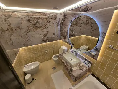 a bathroom with a sink and a toilet and a mirror at Highend 2BR Skyline View with Beach JBR in Dubai
