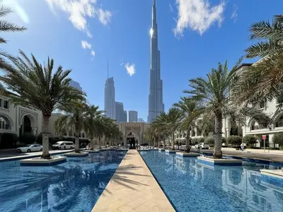 a view of the burj khalifa from the dubai mall with trees at Dubai Studio with Balcony, Canal Views Pool Access in Dubai