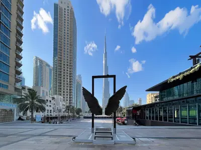 a statue of an eagle on a city street at Dubai Studio with Balcony, Canal Views Pool Access in Dubai