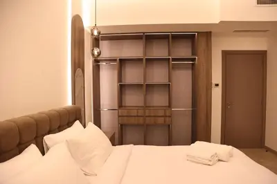 a bedroom with a bed and a book shelf at Highend 2BR Sea and Beach View in Dubai