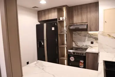 a kitchen with a black refrigerator and a stove at Highend 2BR Sea and Beach View in Dubai