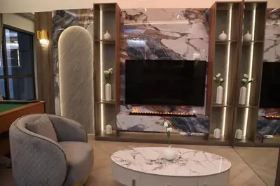 a living room with a fireplace and a tv at Highend 2BR Sea and Beach View in Dubai