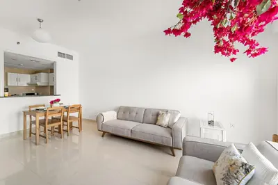 a living room with a couch and a table at FIRST CLASS 2BR Cozy City Retreat in Dubai