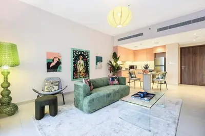 a living room with a green couch and a table at FIRST CLASS 1BR Classic Luxe Getaway in Dubai
